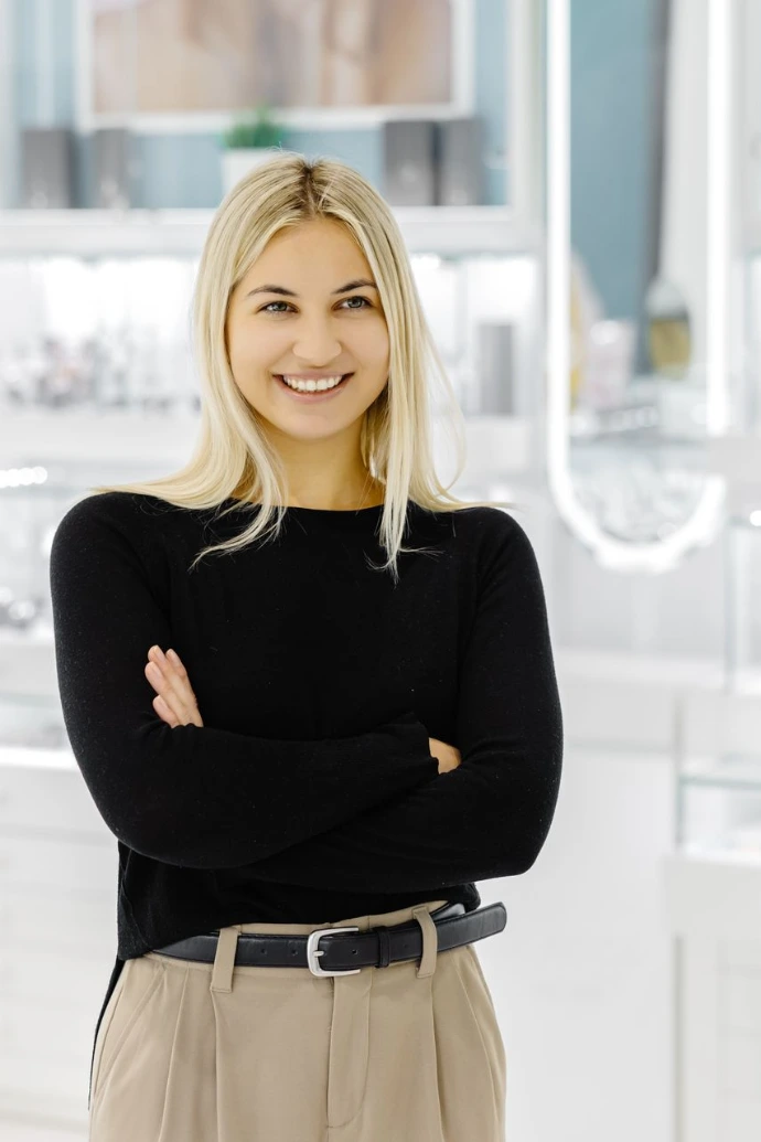 Smiling shop assistant showing jewelry in a jewelry store