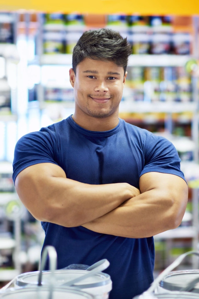 Confident Man with Muscular Build Poses Indoors